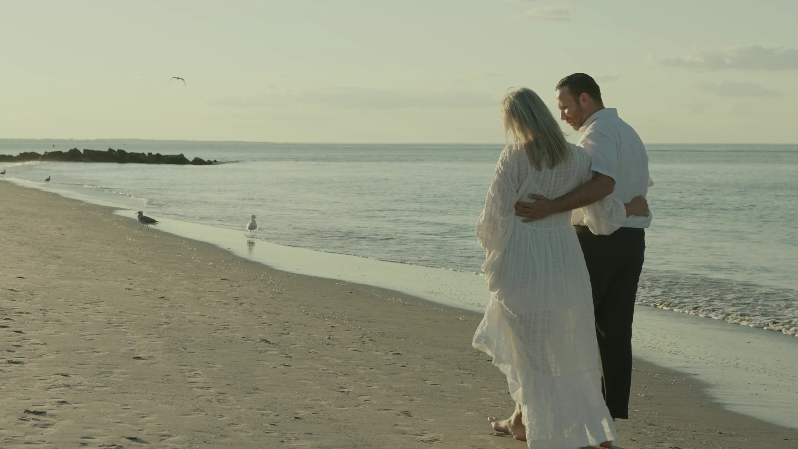 A couple sharing a walk along the beach.